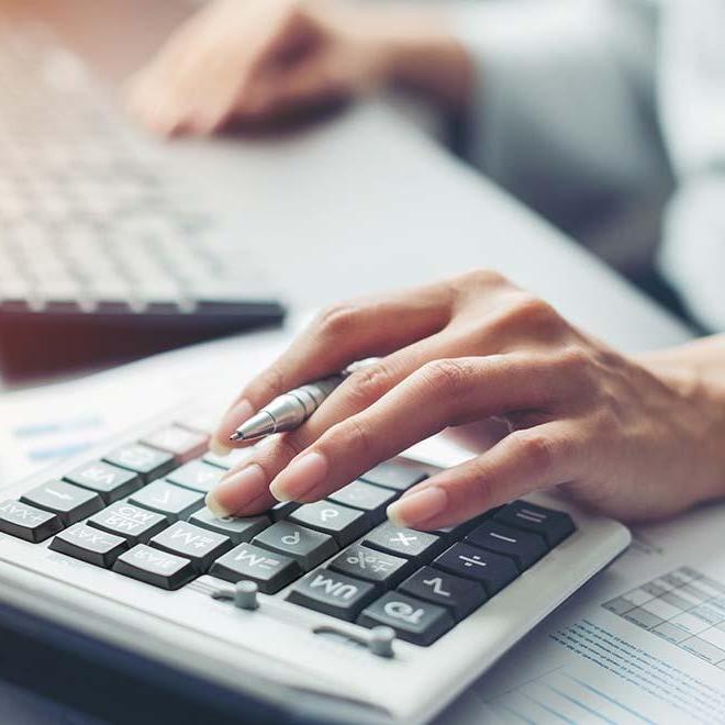 Closeup of woman’s hand on calculator